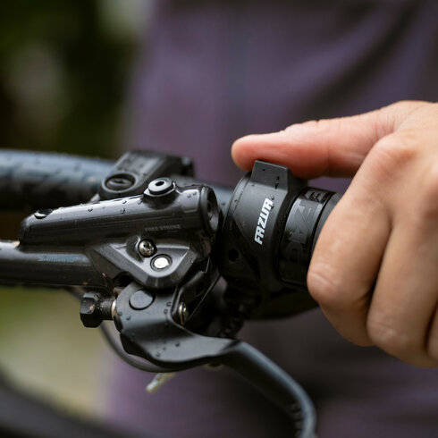 Ein weißer Flurbereich mit einer offenen Garderobe, Kissen und einem kleinen schwarzen Schild